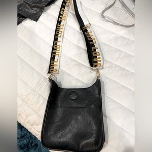 Ah-Dorned black crossbody suede bag with guitar strap